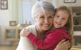Caucasian grandmother and granddaughter hugging